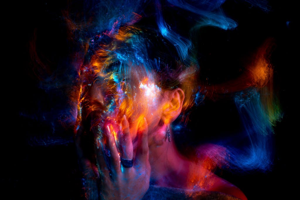 Vibrant long exposure portrait with colorful light painting effects.
